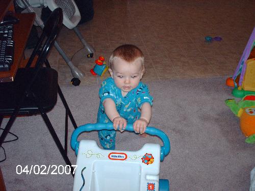 Julian using a walker - This is my son using his walking toy for the first time! He is very proud of himself!
