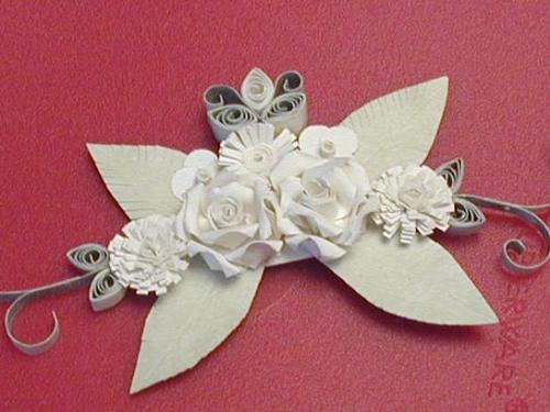 Quilled Wedding Flowers - I quilled these wedding flowers for my mother's scrapbook. Unfortunately my daughter pulled it apart while no one was looking!