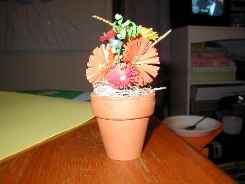 Quilled Flower Pot - I quilled this flower pot for my grandfather. He had been admitted to ICU and wasn't allowed to have real flowers.   They were put on display at his funeral and have since resided on my aunt's bedside table.