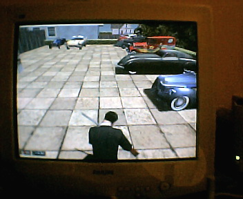 Image from Mafia - Tommy in front of some cars.