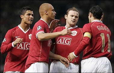 Goal celebration - Man Utd's Portugese midfielder Christiano Ronaldo and British forward Wayne Rooney are congratulated by teammates after Man Utd's first goal