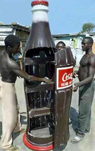 Coca cola coffin - Coca cola coffin: Young carpenters open a coffin shaped like a coca cola bottle in the Ghanaian capital of Accra.  For more info visit the link: www.flatrock.org.nz