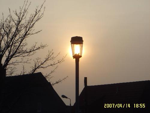 Sun behind the street lamp. - As the sun began to sink in the sky it appeared to light up the street lamp.  Taken using the 'backlight' setting on my digital camera.