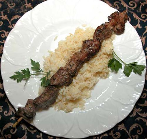 Lamb souvlaki - A skewer of tender, marinated lamb over rice