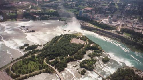 Niagara Falls from the air - This picture shows both the falls at Niagara from above. The helicopter ride was just spectacular! We could see where the river split to make the two falls, then come back together into one river again.
