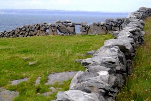 Stone wall in the Burren, Ireland - This is an ancient stone wall in the Burren, in Ireland. THe Burren is an area of Ireland that was over-pasturized 1000 years ago, and still hasn't completely restored itself. Anyhow, this is out near the atlantic, and it's beautiful.
