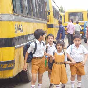 school children - Terror-stricken children in a hurry to board school buses after a bomb hoax in the Maharishi Vidya Mandir Public School, Kalipur in Guwahati, Asom.