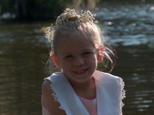 smile - A beautiful child smiles to have her picture taken, as the sun sets behind her.