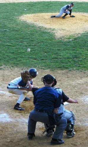 fly ball - pitcher loses his balance and ball beams straight at the helmet of the batter up