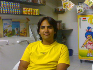 me at my shop - this is the picture when i had trimmed my hair 2 months ago. i didnt liked it so m again goin to grow my hair. this pic is from my shop. well i own this shop of amul as a franchise in gujarat state of India.