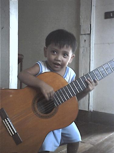 my little angel - my baby seth playing his papa's acoustic guitar.