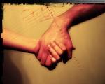 Love - two people holding hands.