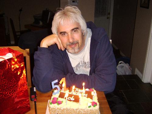 My 51 st birthday!!! - Hi my name is Rob and I just had a 51st birthday this past March. Most of my friends do not believe that I am 51 years old because they think I act so childish.I do not care what they think cause I can pick my friends as easily as picking my nose. If I look excited in the photo it's because I just finished a 12 hr shift.Yeah yeah I could not even get out early for such a monumental occasion. My future wife bought me this tasty cake,I told her no way are you going to place all 51 candles on my cake 1)I do not think I have the wind power to blow them all out 2)I just know that it would probably set off the smoke alarm 3)I didn't want that much wax on my cake.  She also bought me a Harley Davidson motor cycle, but that's out side that's why you can not see it. I hope you enjoy my profile and my interests, toodles
