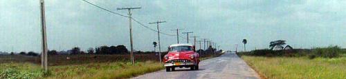 Old American car in Cuba - Old American car in Cuba driving down one of the lonely roads.
