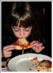 child eating - a child eating something like a pizza. can be associated with kids. a cute kid