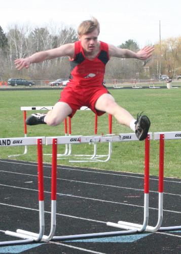 Hurtler at the top of his jump. - I have been trying for years to catch a hurtler at the top of the jump and get the face. Since I make money by selling the photos to people they want the action and to see their child. To me this is an almost perfect picture you see the action and the expression on his face. I was lucky with this track because the home stretch of this track i had the sun light off to the side and it was a slightly overcast day so I had no harsh light to deal with.