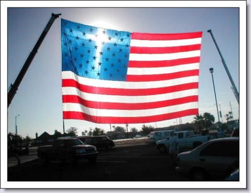United States Flag with reflection of the sun behi - The United States Flag with the reflection of the sun shining through, forming a cross from the stars reminds us that God is watching over our nation. United States Flag with reflection of the sun behi - The United States Flag with the reflection of the sun shining through, forming a cross from the stars reminds us that God is watching over our nation.
