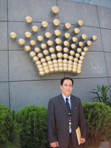 Crown Macau  - This is my picture with the Crown Macau Logo in the background. Crown will be opening to the public on May 09, so come and visit us and have fun at our Gaming Tables and Slot Machines.