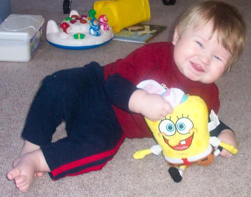 A newer photo of Dustin, with the Bunny Spongebob  - Since my hubby celebrates Easter, he got Dusty this little bunny Spongebob. And boy is it a hit! He loves Spongebob anyway, and he seems determined to eat the ears. =p