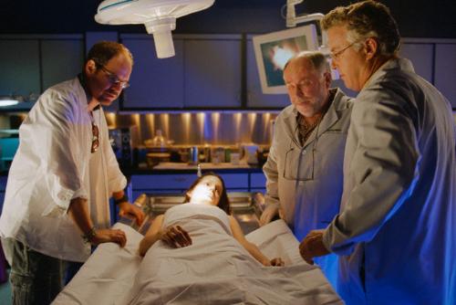 cast on the set of CSI - (L-R) Actors William Petersen (as Gil Grissom) and Robert David Hall (as coroner Al Robbins) examine a corpse in a scene from CSI