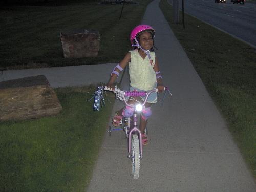 little girl on bicycle -  This is summer night just after having fun for hours riding through the neighbourhood.