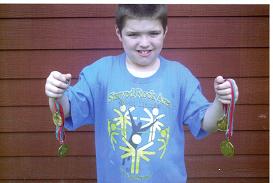 He Did It Again! - CJ now has a total of 4 Gold Medals in Special Olympics. Two for individual basketball skills and two for track-n-field! He gets to go to State again on June 15th and he&#039;s so very excited! We are going to work hard with training some more before that time comes so that he&#039;ll do even better when the big day comes. The State medal is much larger than the regional. Next year we&#039;re hoping to get him into the standing long jump as well.