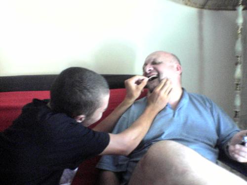cleaning teeth - Armandt cleaning his dad's teeth