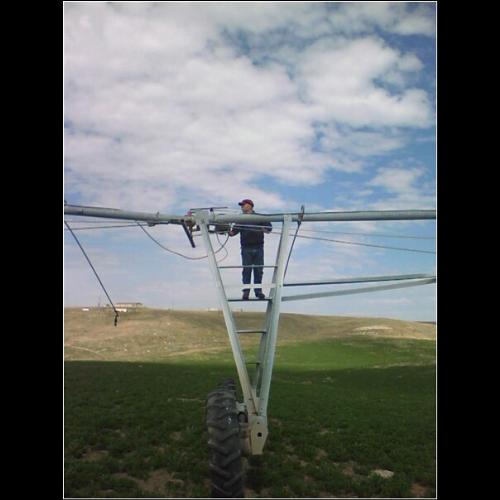 My boyfriend - This is a picture of my boyfriend working on the pivot in our hay field.