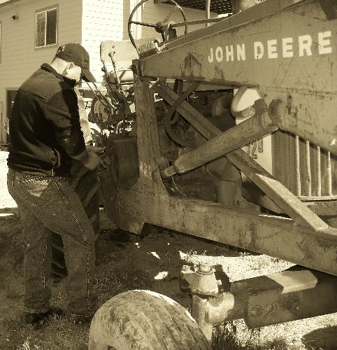 My boyfriend - I love when my boyfriend works on the farm. I thought this was an interesting shot to take in sepiea tone. The tractor is very old so it really set the mood.