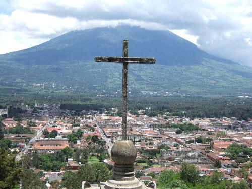 Cross, City of Antigua - If you climb on top of this hill at the outskirts of Antigua, Guatemala you'll find this cross looking down on the entire city. From this perspective, you see the city, the cross, and the Volcano on the opposite side of Antigua.