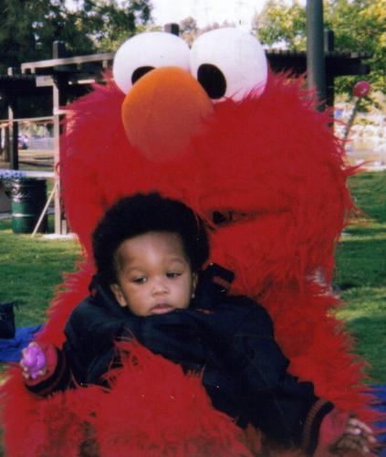 My Great- Nephew, Jeremiah -  This is Elmo, holding Jeremiah at his 1st birthday. The person in the costume was a lady and Jeremiah was much to heavy for her, but she did her best to hold the big ham.