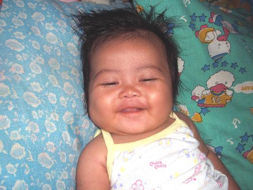 my baby at 4 months old - this is my baby louviemin elyzon at 4months old... she just woke up and smiled! she loves eating rice cereals and watching television...her name came from the combination of the names of her grandparents... abit long, but i wanted to show our parents how we love them so much that we named our first child from them....
