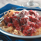 Italian Spaghetti Sauce with Meatballs -  PREP TIME 20 Min  COOK TIME 2 Hrs  READY IN 2 Hrs 20 Min   INGREDIENTS: MEATBALLS: 1 pound lean ground beef 1 cup fresh bread crumbs 1 tablespoon dried parsley 1 tablespoon grated Parmesan cheese 1/4 teaspoon ground black pepper 1/8 teaspoon garlic powder 1 egg, beaten  SAUCE: 3/4 cup chopped onion 5 cloves garlic, minced 1/4 cup olive oil 2 (28 ounce) cans whole peeled tomatoes 2 teaspoons salt 1 teaspoon white sugar 1 bay leaf 1 (6 ounce) can tomato paste 3/4 teaspoon dried basil 1/2 teaspoon ground black pepper   DIRECTIONS: 1. In a large bowl, combine ground beef, bread crumbs, parsley, Parmesan, 1/4 teaspoon black pepper, garlic powder and beaten egg. Mix well and form into 12 balls. Store, covered, in refrigerator until needed. 2. In a large saucepan over medium heat, saute onion and garlic in olive oil until onion is translucent. Stir in tomatoes, salt, sugar and bay leaf. Cover, reduce heat to low, and simmer 90 minutes. Stir in tomato paste, basil, 1/2 teaspoon pepper and meatballs and simmer 30 minutes more. Serve.