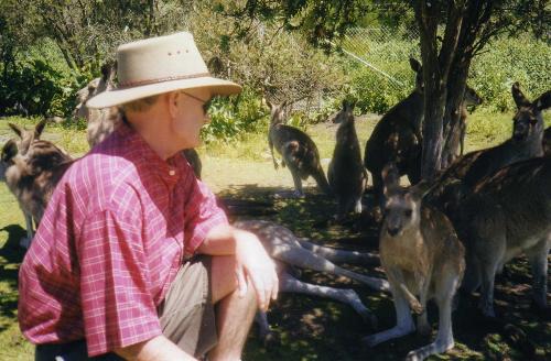 Hangin wid de Kangas - Here's me with a few unusual furry friends in Oz. These guys were very chummy. You just don't startle them. They can be very insistent on forming a relationship usually based on something to eat. This is a perfect opportunity to feel just how powerful they are when you feel those paws mooching around in yours. I just love the way they all hang together.