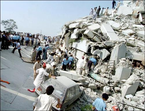 Picture of an earthquake&#039;s wake - Earthquake rubble with people scrambling to give help or to look for some help. 