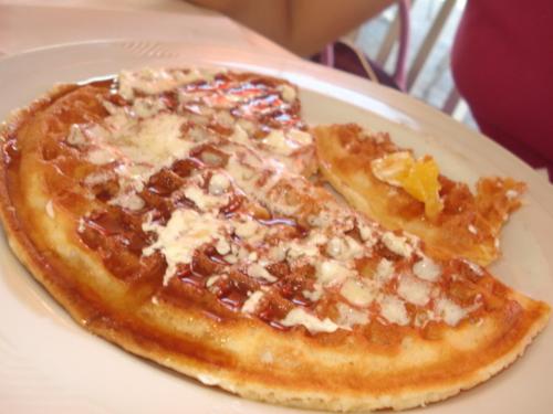 delicious waffle - The picture shows a very mouth-watering waffle, which is drenched in tasty butter and yummy syrup.