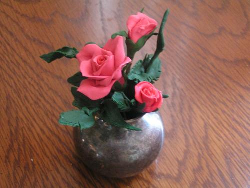 clay roses - These are minature roses that I made out of polymer clay. They are not painted. The color is in the clay. It is easy to work with and bakes in a regular kitchen oven.