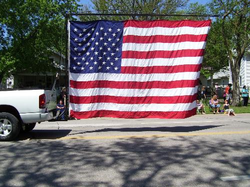 A very large flag - This flag was displayed behind a truck in our local parade. Everyone in the crowd that I could see, stood and had respect. There were many flags in this parade. A very large flag - This flag was displayed behind a truck in our local parade. Everyone in the crowd that I could see, stood and had respect. There were many flags in this parade.