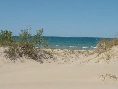 Sleeping Bear Dunes  - The Sleeping Bear Dunes National Lakeshore is one of over 380 National Park sites administered by the National Park Service. It is located in northwest Lower Michigan on Lake Michigan.   The Dunes carry a legendary story that involves a mother bear and her two cubs. They were escaping Wisconsin where there was a fire and swam Lake Michigan ending up on the Michigan side of the lake. The mother bear reached the shore and climbed up a cliff to watch for her cubs. They didn't make it though and while the mother bear became the Sleeping Bear Dunes the two cubs became North and South Manitou Island which is just off the shore where their mother waited.  Also some of the largest and best cherry orchards in the states are located in the area so if you like cherries plan on visiting during harvest time - you will certainly get your fill.