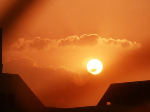 The Morning Sun - A picture of the sun rising through an airplane window.