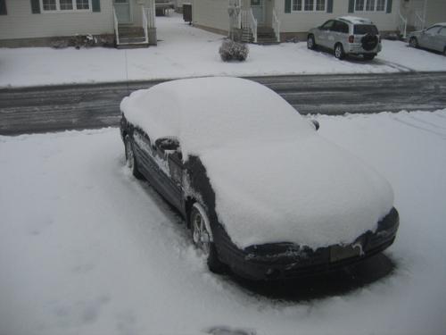 Snowy Moncton - My black Grand Am covered in snow after a mild snow storm in Moncton, New Brunswick.