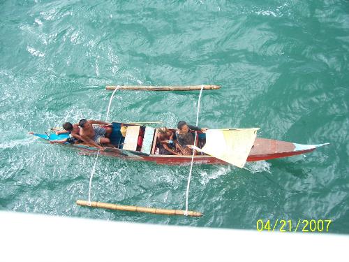 A Bajao family chasing our ship - A Bajao family onboard their bangka chasing the our ship for some coins and money. 