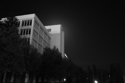 moon behind building  - in this photo the moon was behind the top of the building causing an interesting effect.