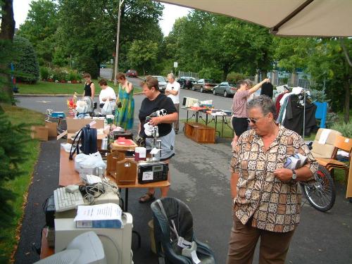 garage sale - people checking and buying in a garage sale