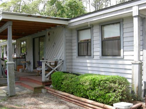 Our house - This is our "mobile home". It is rated this way because my husband built it around the old single-wide mobile home we were living in during the construction. He did not move the frame or the tongue of the mobile home which is just about all that's left of the original place. That and the fact we are not on a permanent foundation makes it a mobile home according to insurance companies. Our house - This is our "mobile home". It is rated this way because my husband built it around the old single-wide mobile home we were living in during the construction. He did not move the frame or the tongue of the mobile home which is just about all that's left of the original place. That and the fact we are not on a permanent foundation makes it a mobile home according to insurance companies.