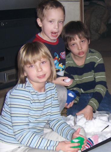 My son and 2 of my grandchildren - This is a photo of my son and 2 of my granchildren playing with snow in the middle of my living room floor...it was the first snow of last winter...and the wind was so cold outside...the kids were so anxious to play in the snow...so I spread a blanket on the floor and brought in a large container of fresh snow....they spent hours playing in the snow with their cars, trucks and cooking utensils....  Winter...Tina sytle...LOL