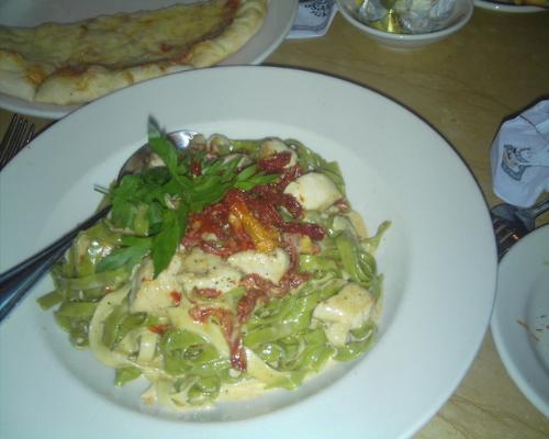fettucine - a serving of fettucine with chicken and tomatoes