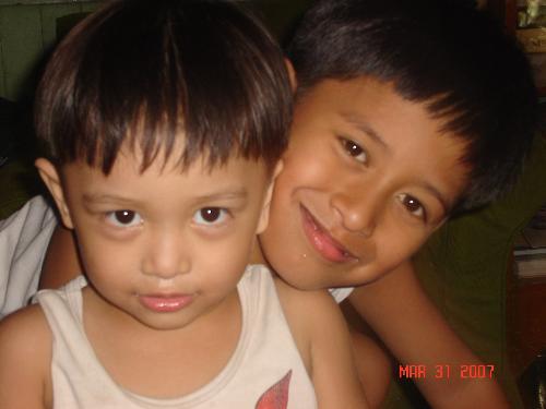 My SONS - These are my 2 sons. The older one is 8 y.o and the younger one is almost 3 y.o. In the photo you can see that my older son is hugging my younger son with my younger son urging his big brother to hug him and pose. Though they have a great gap in age, they do carry on great. They are very close to each other.