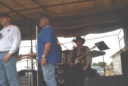 'ya'll shut-up and let me sing!' - Waiting to sing a song, at the Odell,Tx.Volunteer Firefighter's Benefit,April 28,2006. We had lots of fun, lots of music, and lots of good food! But I'm not going to mention all the good looking women! I'll get in trouble!