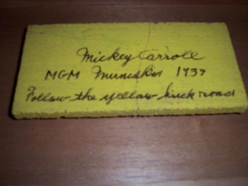 Piece of the Yellow Brick Road from The Wizard of  - This is one of many movie props in my collection. This is an original brick, previously part of the yellow brick from the 1939 movie 'The Wizard of Oz'. It is signed by munchkin Mickey Carroll.